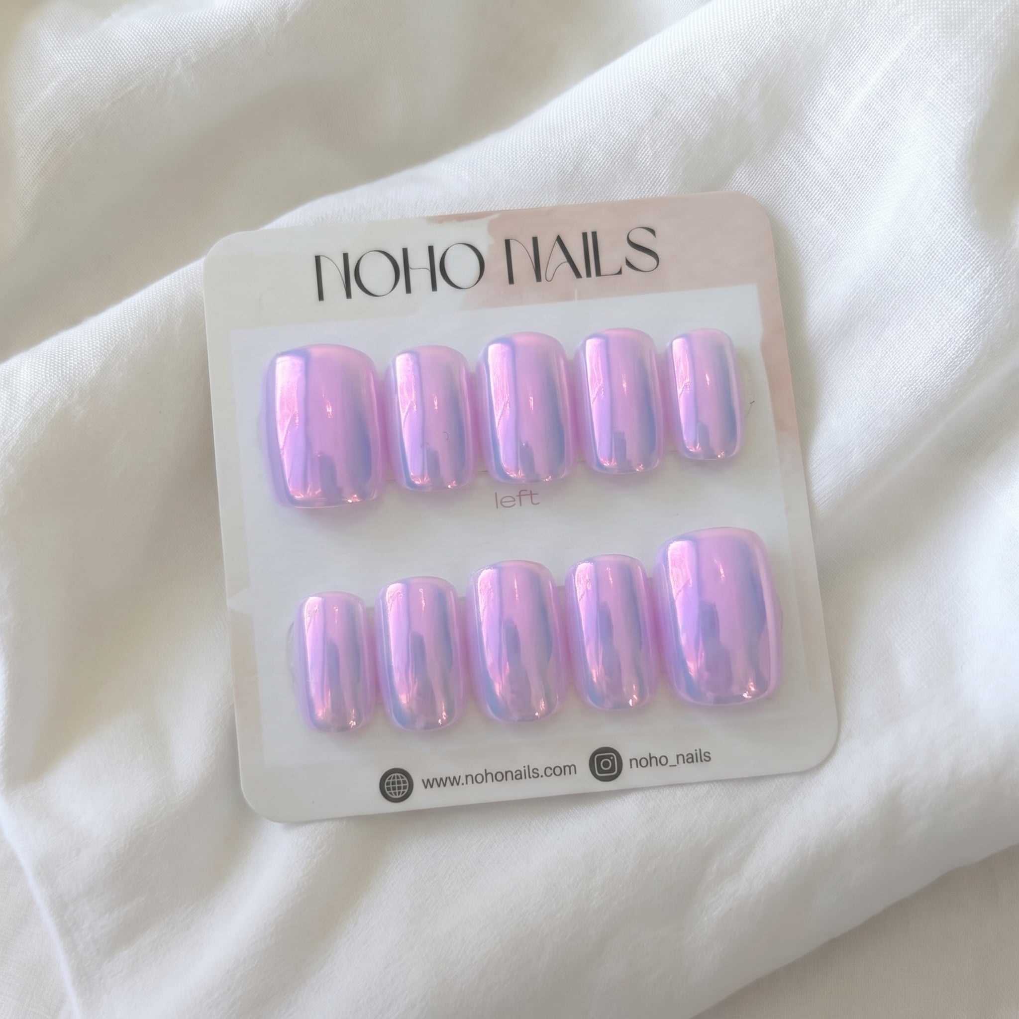 Purple Moonlight press-on nails by Noho Nails: ten short square lavender nails with pink aurora chrome on a Noho Nails display card