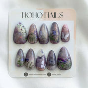 Set of floral nail art designs on a Noho Nails branded card.